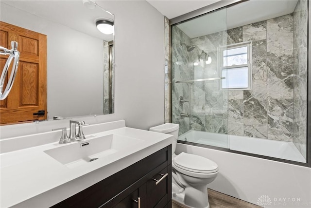 full bathroom with vanity, toilet, and combined bath / shower with glass door