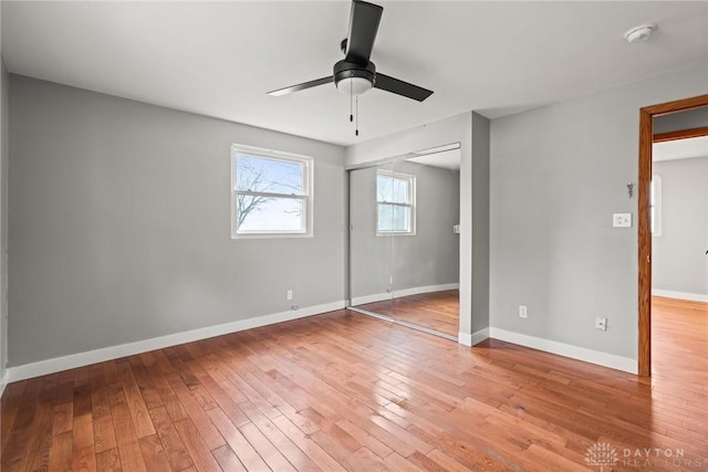 unfurnished bedroom with a closet, ceiling fan, and light wood-type flooring