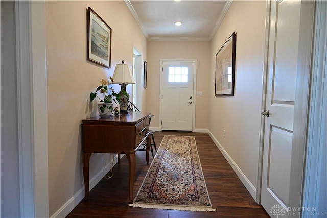 doorway to outside featuring dark hardwood / wood-style flooring and crown molding