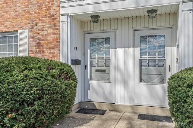 doorway to property with brick siding