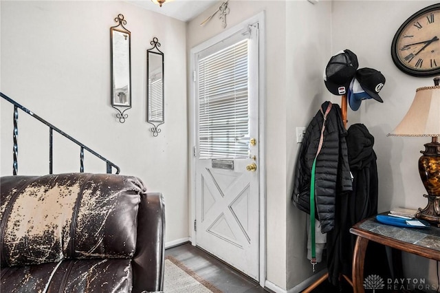 doorway to outside with wood finished floors and baseboards