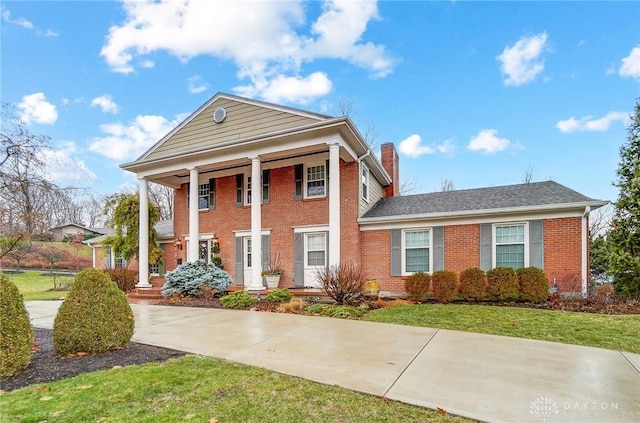 greek revival inspired property with a front lawn