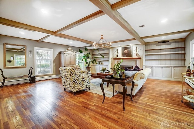 sitting room with light wood-type flooring, a chandelier, built in features, and beam ceiling