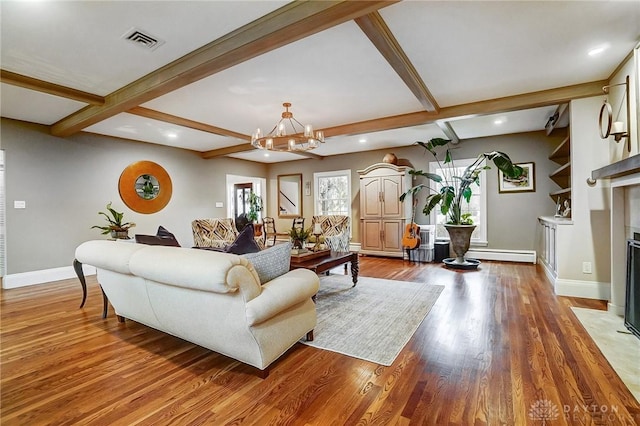 living room with hardwood / wood-style flooring, beamed ceiling, and a chandelier