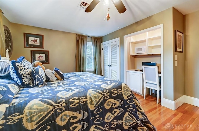 bedroom with light wood-type flooring, a closet, and ceiling fan