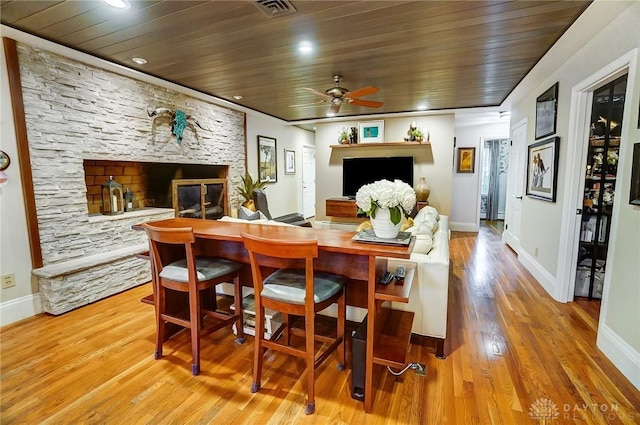 dining area featuring hardwood / wood-style flooring, ceiling fan, and wood ceiling