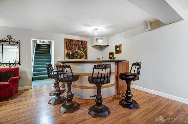 bar with hardwood / wood-style floors