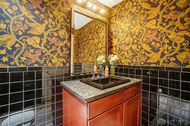 bathroom featuring tile walls and vanity