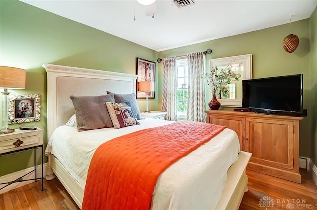 bedroom with hardwood / wood-style floors and ceiling fan