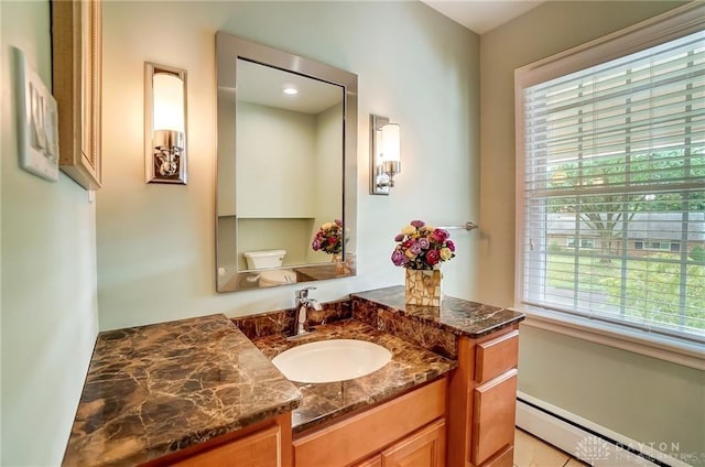 bathroom with toilet, a baseboard heating unit, and vanity