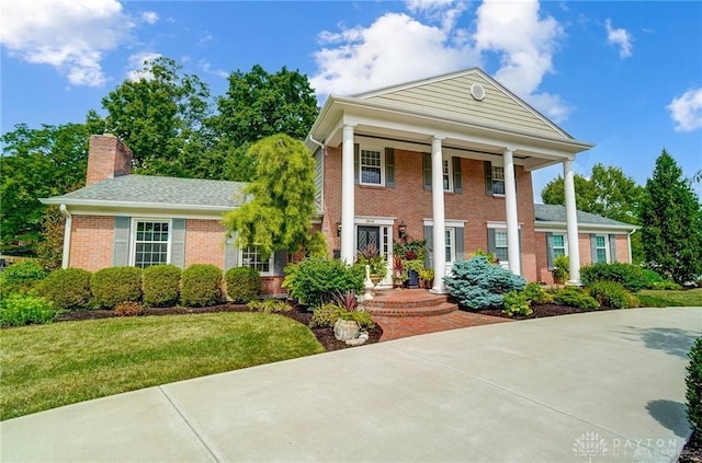 neoclassical home with a front yard