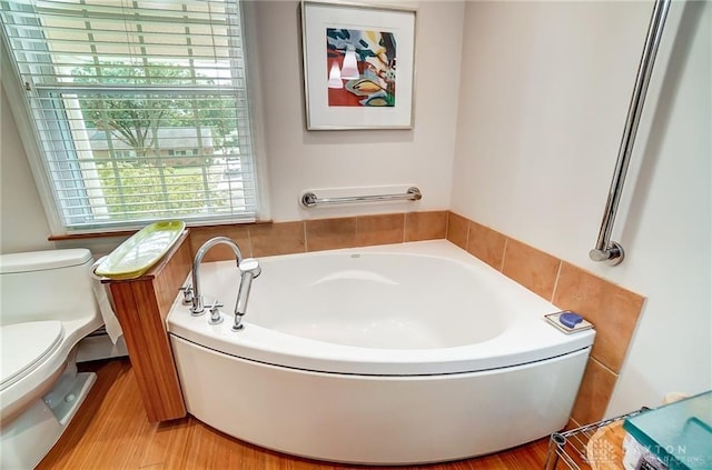 bathroom with toilet and a tub