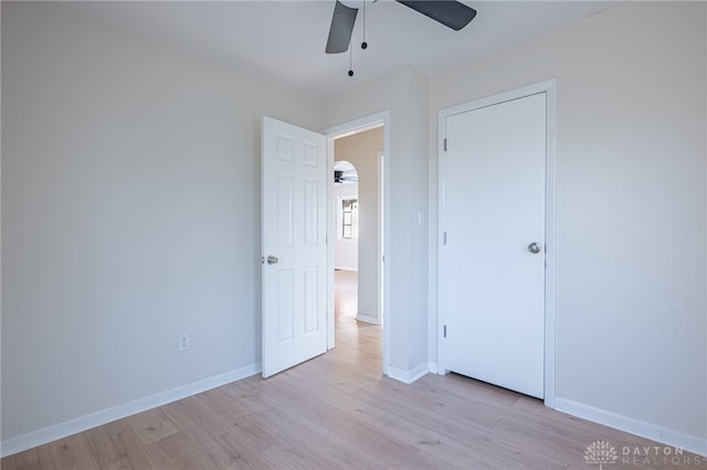 unfurnished bedroom featuring ceiling fan and light wood-type flooring