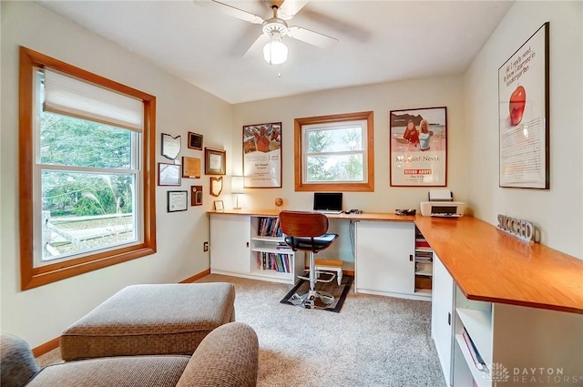 office space featuring light carpet and ceiling fan