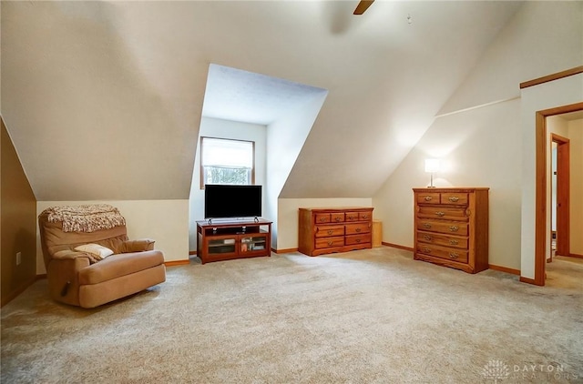 sitting room featuring vaulted ceiling, ceiling fan, and carpet floors