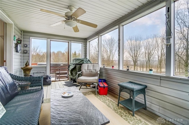 sunroom with plenty of natural light and ceiling fan