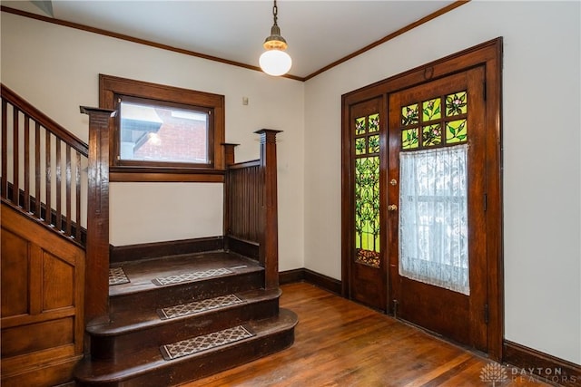 entrance foyer with crown molding and dark hardwood / wood-style floors