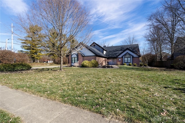 ranch-style home featuring brick siding and a front yard