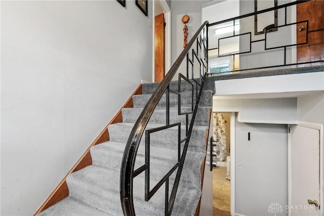 staircase with a towering ceiling