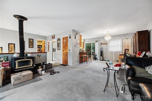 living room with a wood stove and carpet floors