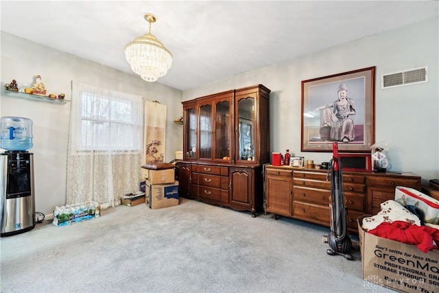 misc room featuring light carpet and a chandelier