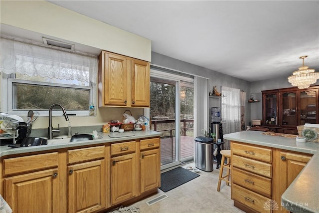 kitchen with sink and a chandelier