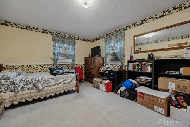 bedroom featuring a textured ceiling and carpet floors