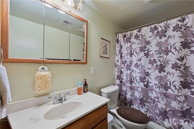 bathroom featuring toilet and vanity