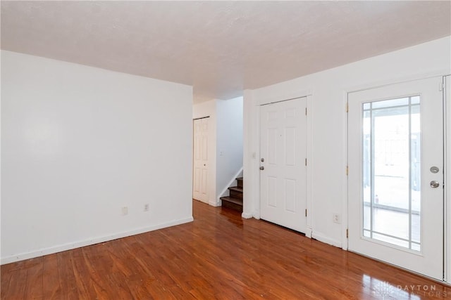 unfurnished room with hardwood / wood-style flooring