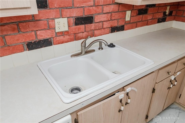 room details featuring sink and light brown cabinetry