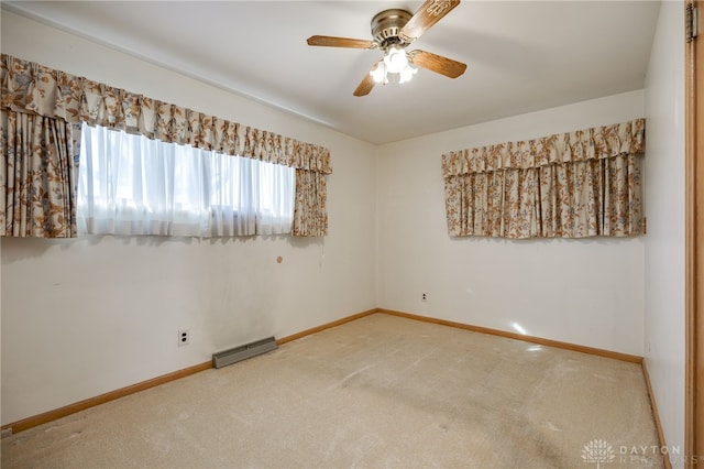 empty room with baseboard heating, ceiling fan, and carpet floors