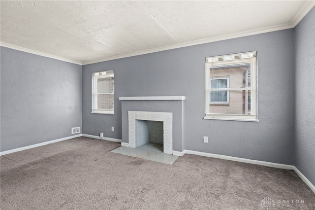 unfurnished living room featuring carpet, a tile fireplace, crown molding, and a textured ceiling