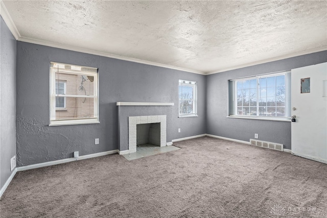 unfurnished living room featuring carpet flooring, crown molding, a textured ceiling, and a tiled fireplace