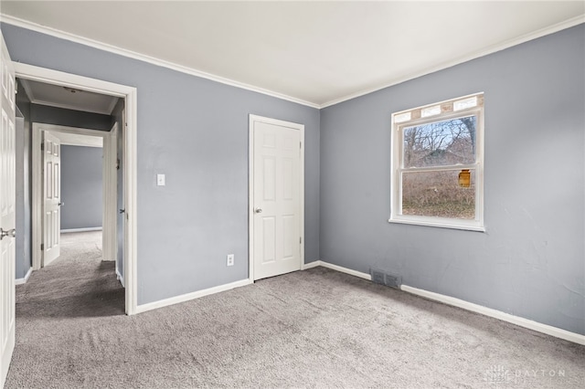 unfurnished bedroom featuring carpet floors and ornamental molding