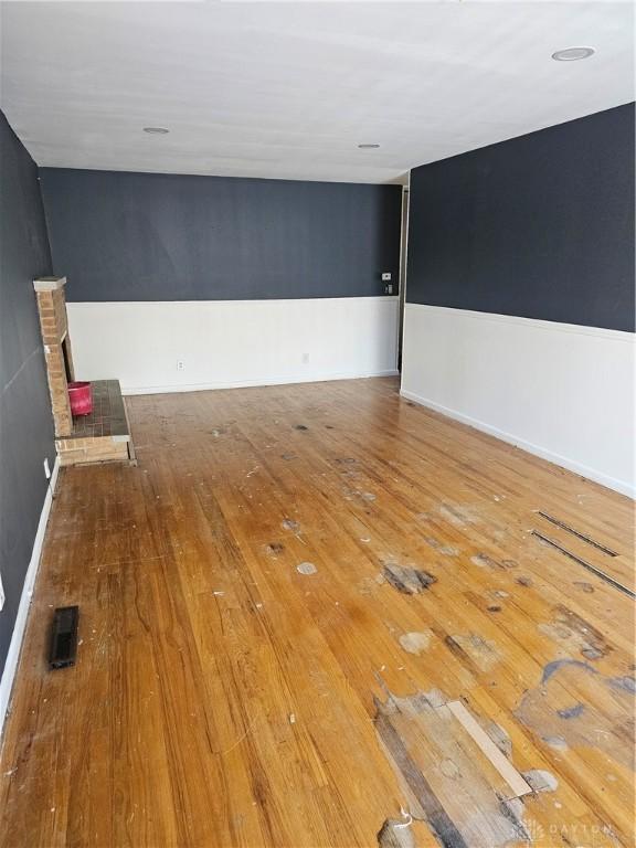 unfurnished room with hardwood / wood-style floors