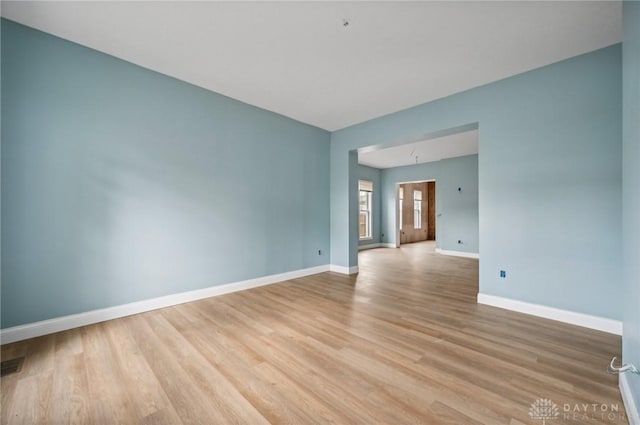 empty room with light hardwood / wood-style flooring