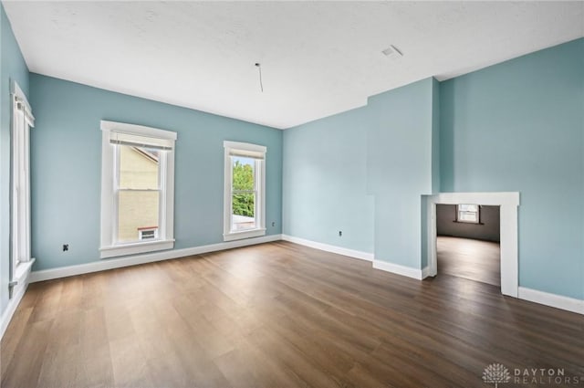 unfurnished room with dark hardwood / wood-style flooring