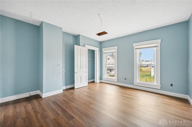 unfurnished bedroom with dark hardwood / wood-style flooring