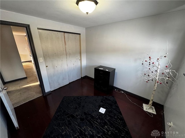 unfurnished bedroom featuring a closet and dark hardwood / wood-style flooring