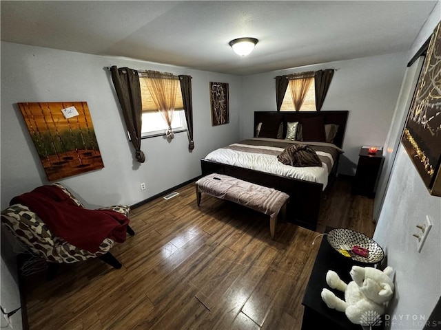 bedroom with dark wood-type flooring