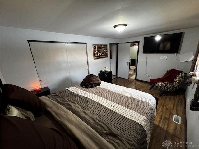 bedroom featuring dark hardwood / wood-style flooring and a closet