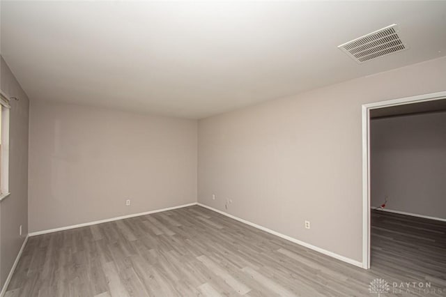 spare room featuring light wood-type flooring