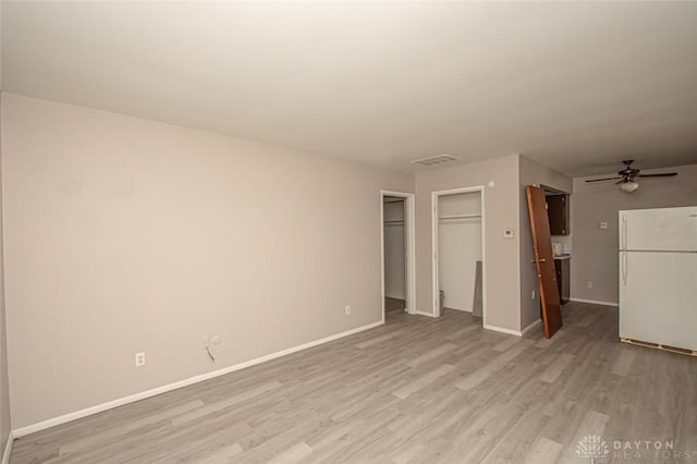 unfurnished living room with light hardwood / wood-style flooring and ceiling fan