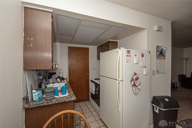 kitchen featuring white appliances and light tile patterned floors