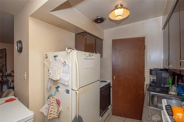 kitchen with electric stove, dark brown cabinetry, white refrigerator, light tile patterned floors, and sink