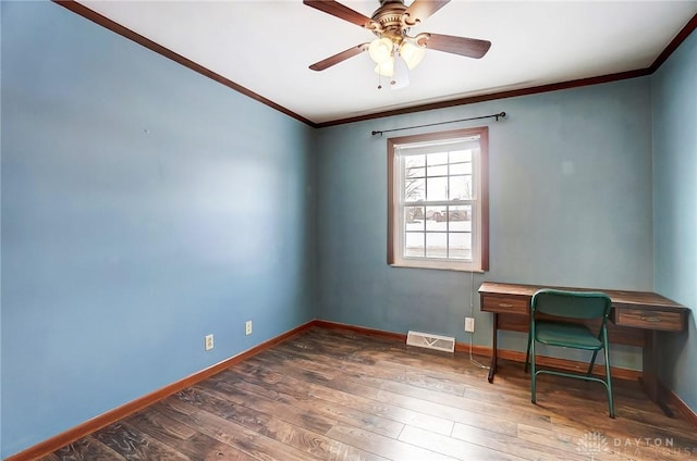 office space featuring dark hardwood / wood-style flooring, ornamental molding, and ceiling fan