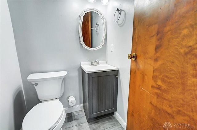 bathroom featuring toilet and vanity