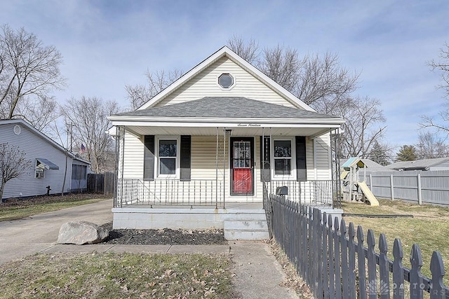 bungalow-style home featuring a playground and a porch