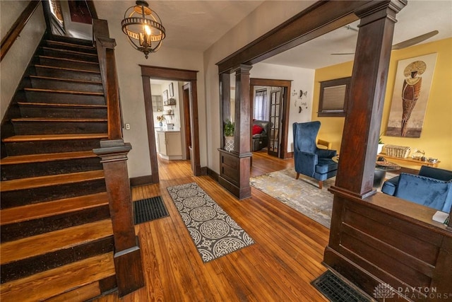 entryway with hardwood / wood-style flooring and ornate columns