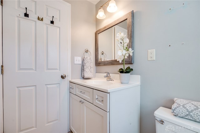 bathroom featuring toilet and vanity